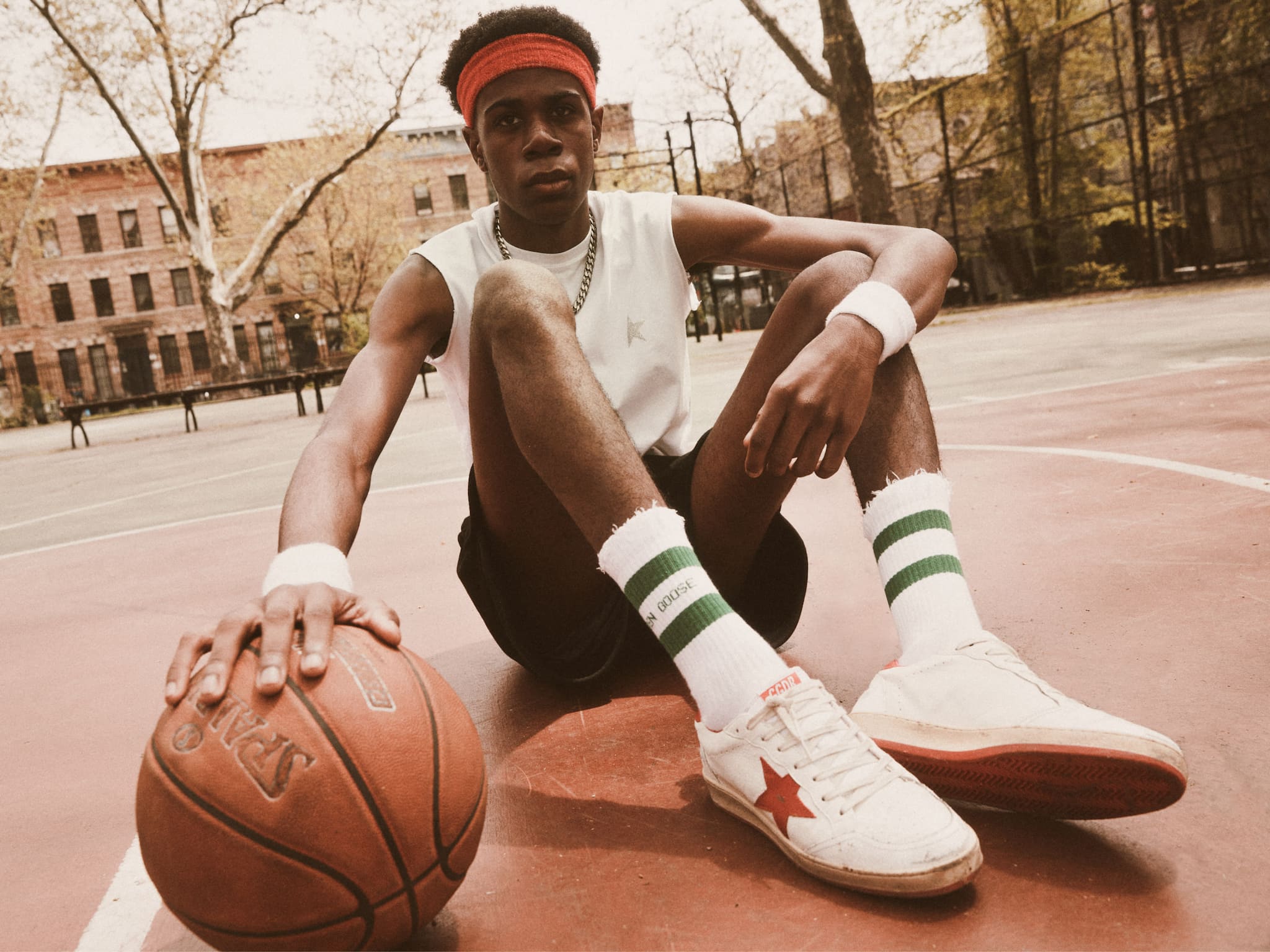 a-future-pro-basketball-player-kid-sitting-with-his-favorite--1980-Ball-Star-on-his-feet