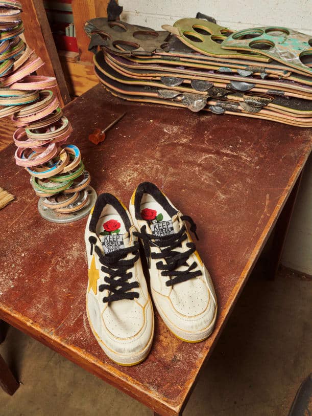 white-with-yellow-star-ball-star-pro-sneaker-front-view-in-skateboard-workshop