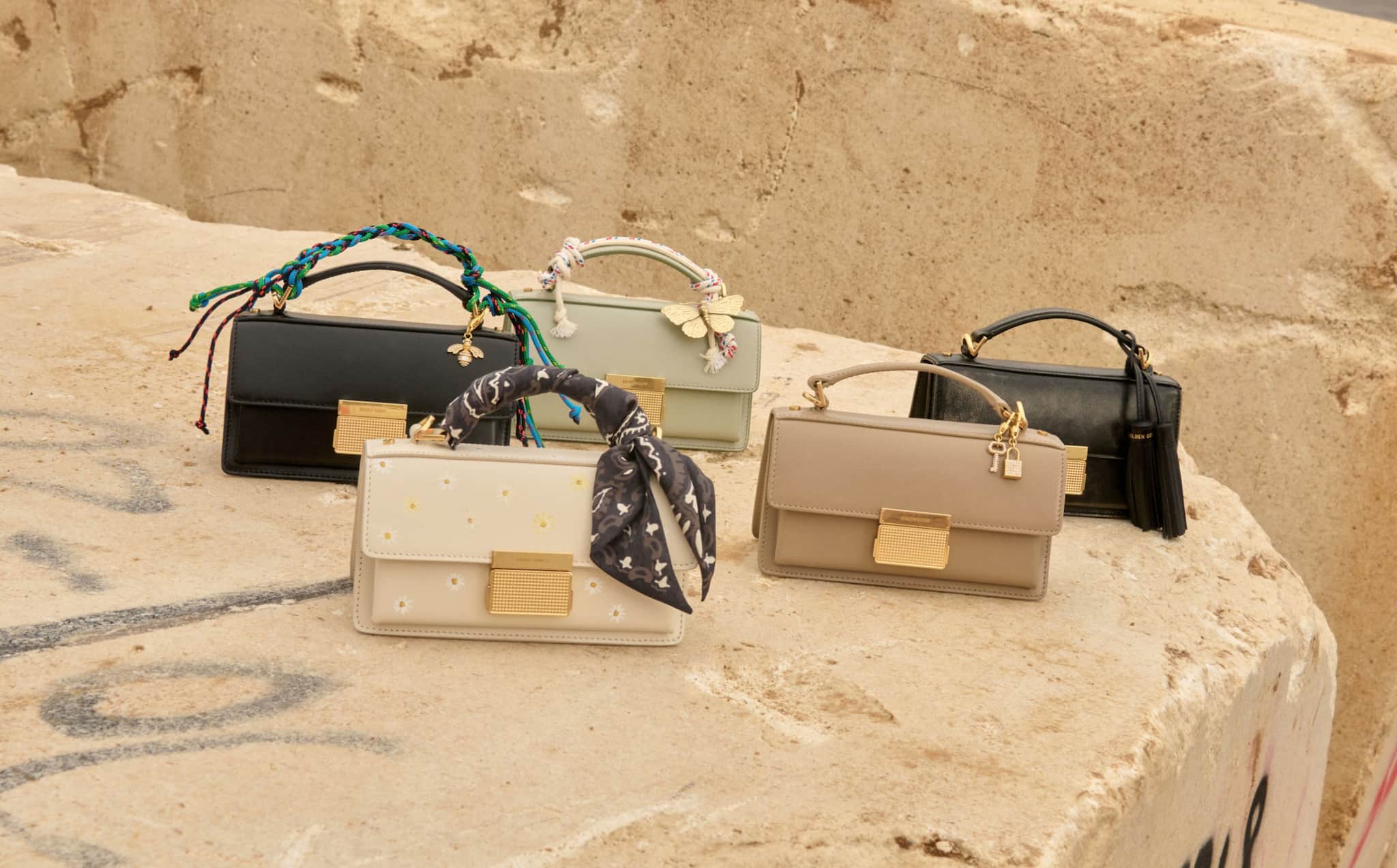 view-of-various-golden-goose-bags-on-a-rock