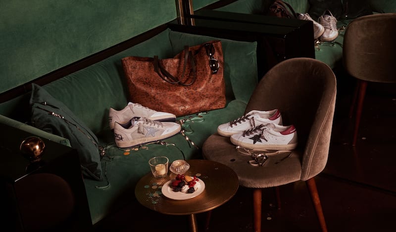 three-pair-of-animalier-printed-sneakers-on-colored-marble-tiled-floor