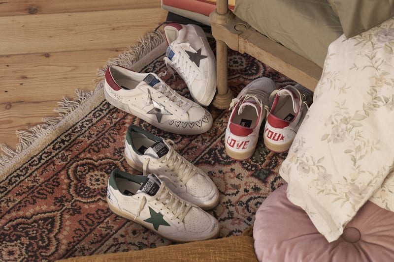 Top-view-of-black-superstar-sneakers-on-parquet-floor