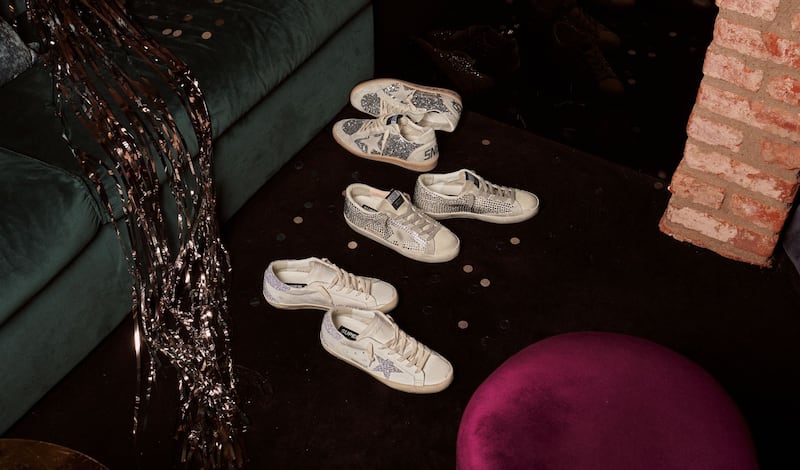 top-view-of-silver-glittered-ball-star-sneaker-on-wooden-floor