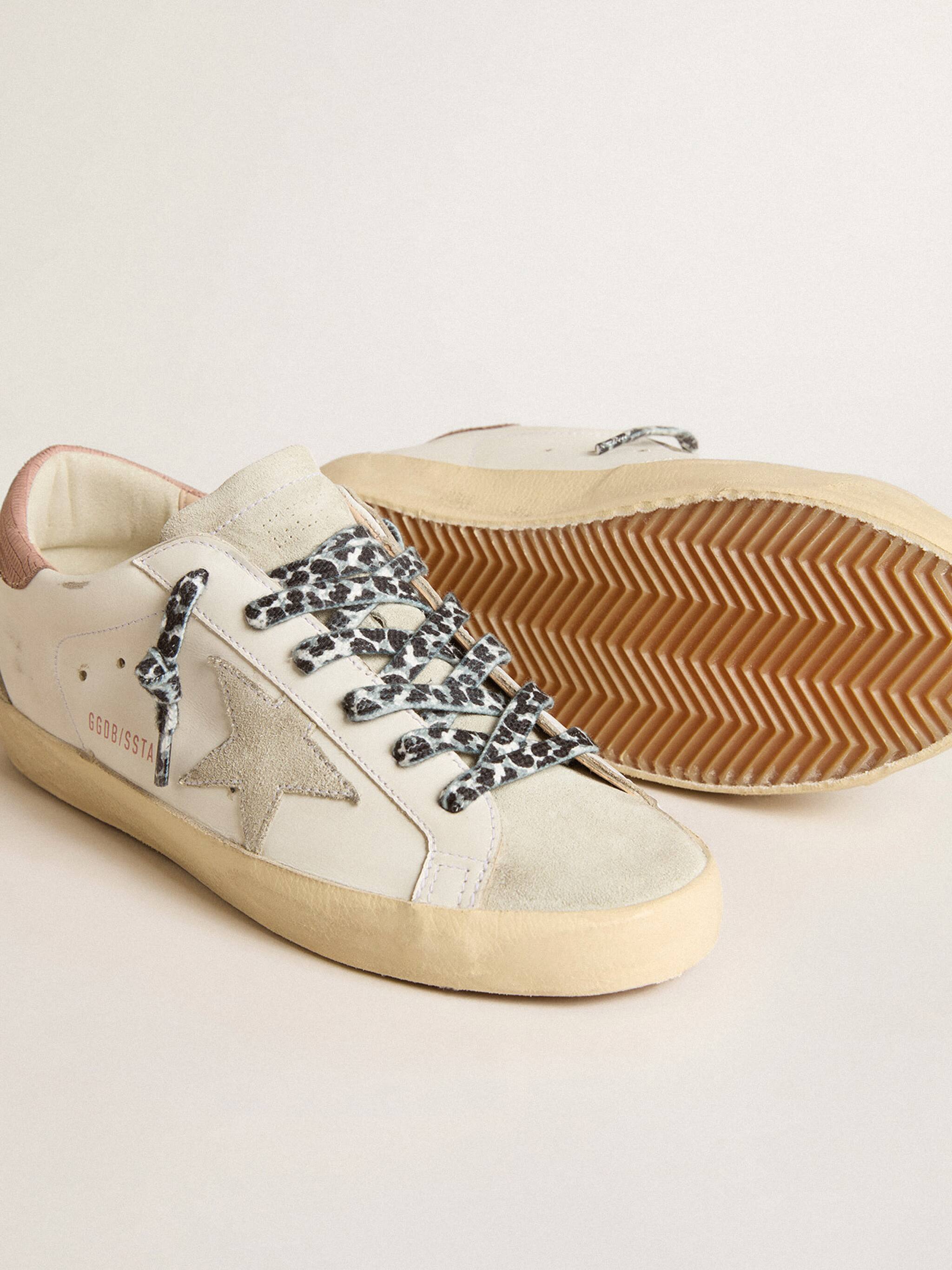 Side-view-of-white-superstar-sneakers-with-pink-heel-tip-and-cow-animalier-textured-laces-grey-suede-stars