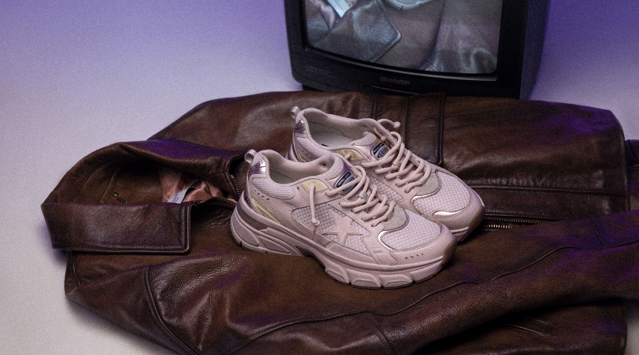 Pink lightstar sneakers with a brown leather jacket