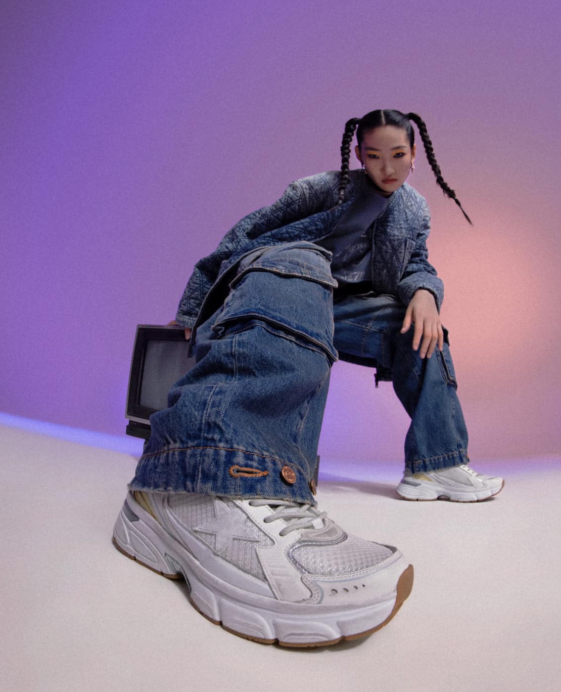 Bottom view of asian woman wearing denim outfit and white lightstar sneakers