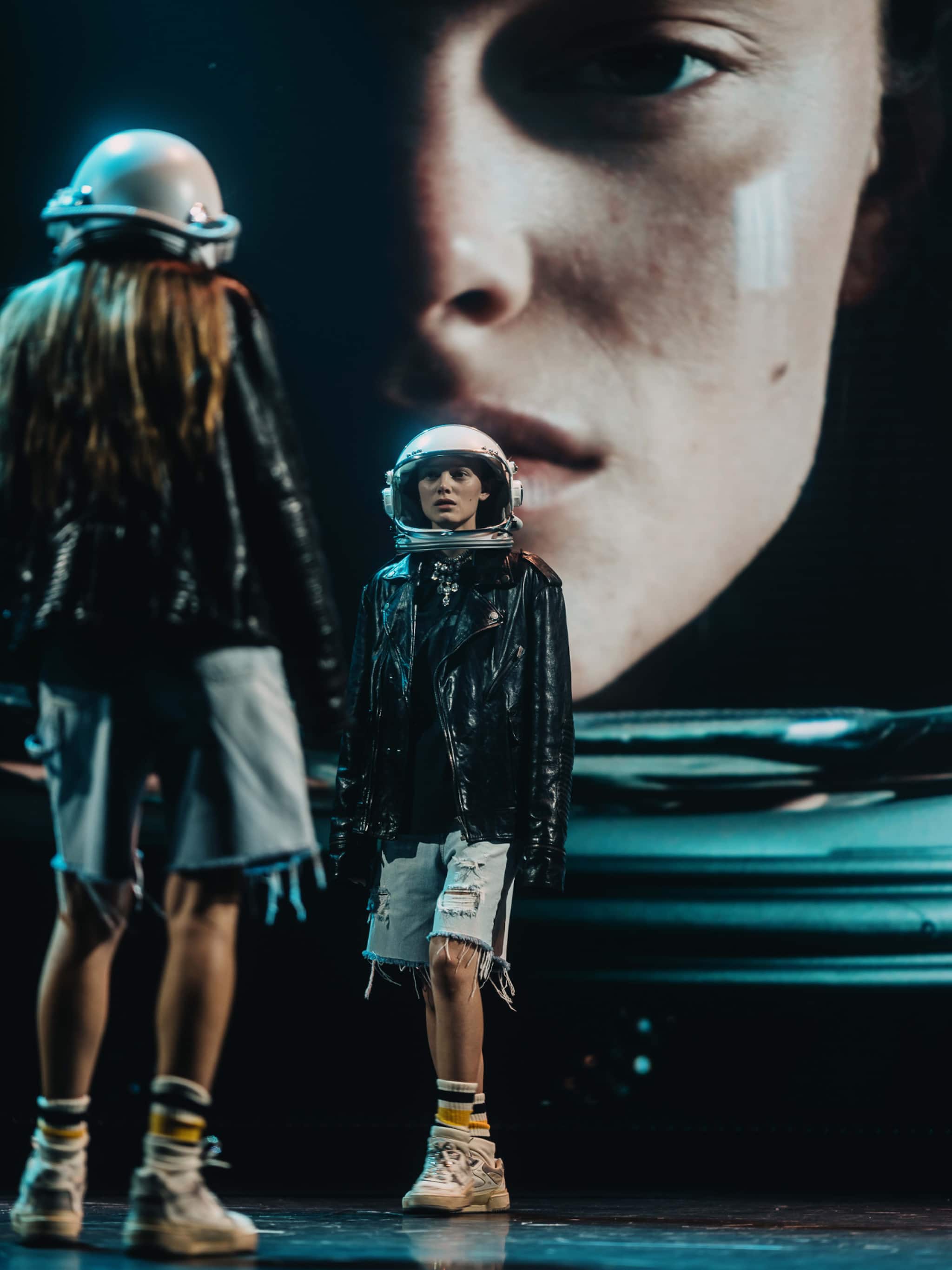 model-bobby-banks-wearing-space-helmet-looks-at-doppelganger-with-her-face-in-the-background