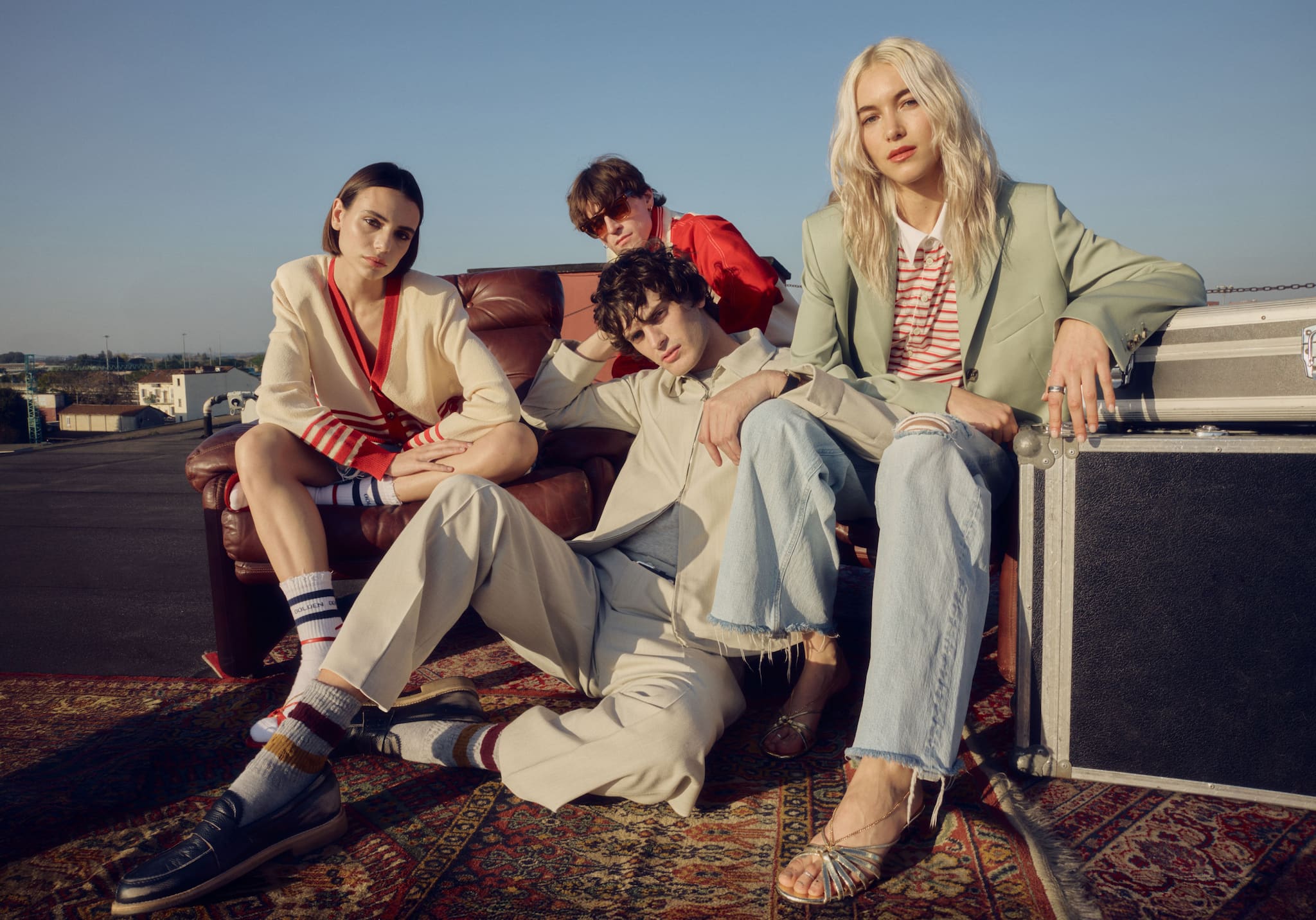 woman-and-man-on-a-cliff-by-the-sea-wearing-golden-goose-summer-clothes