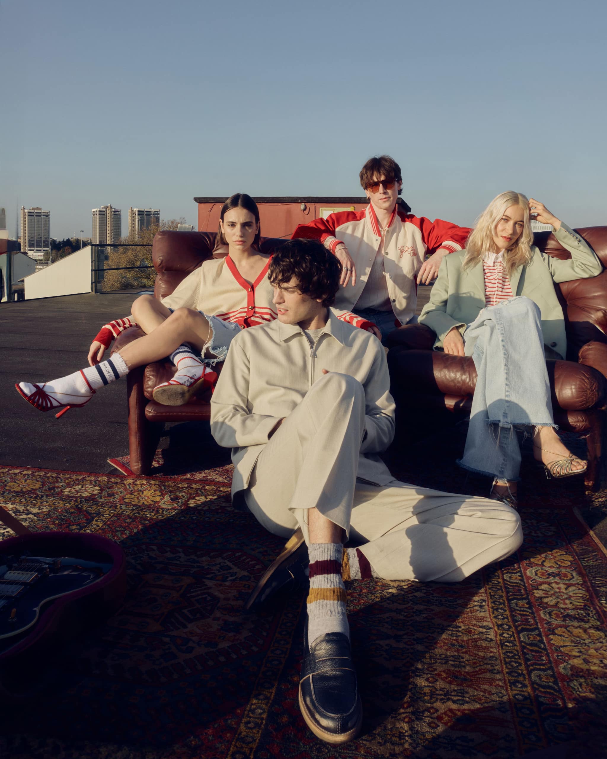 woman-and-man-on-a-cliff-by-the-sea-wearing-golden-goose-summer-clothes