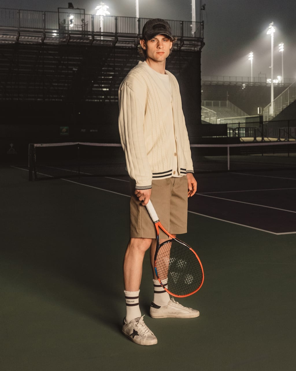 zizou-bergs-tennis-player-in-cardigan-on-court-at-night