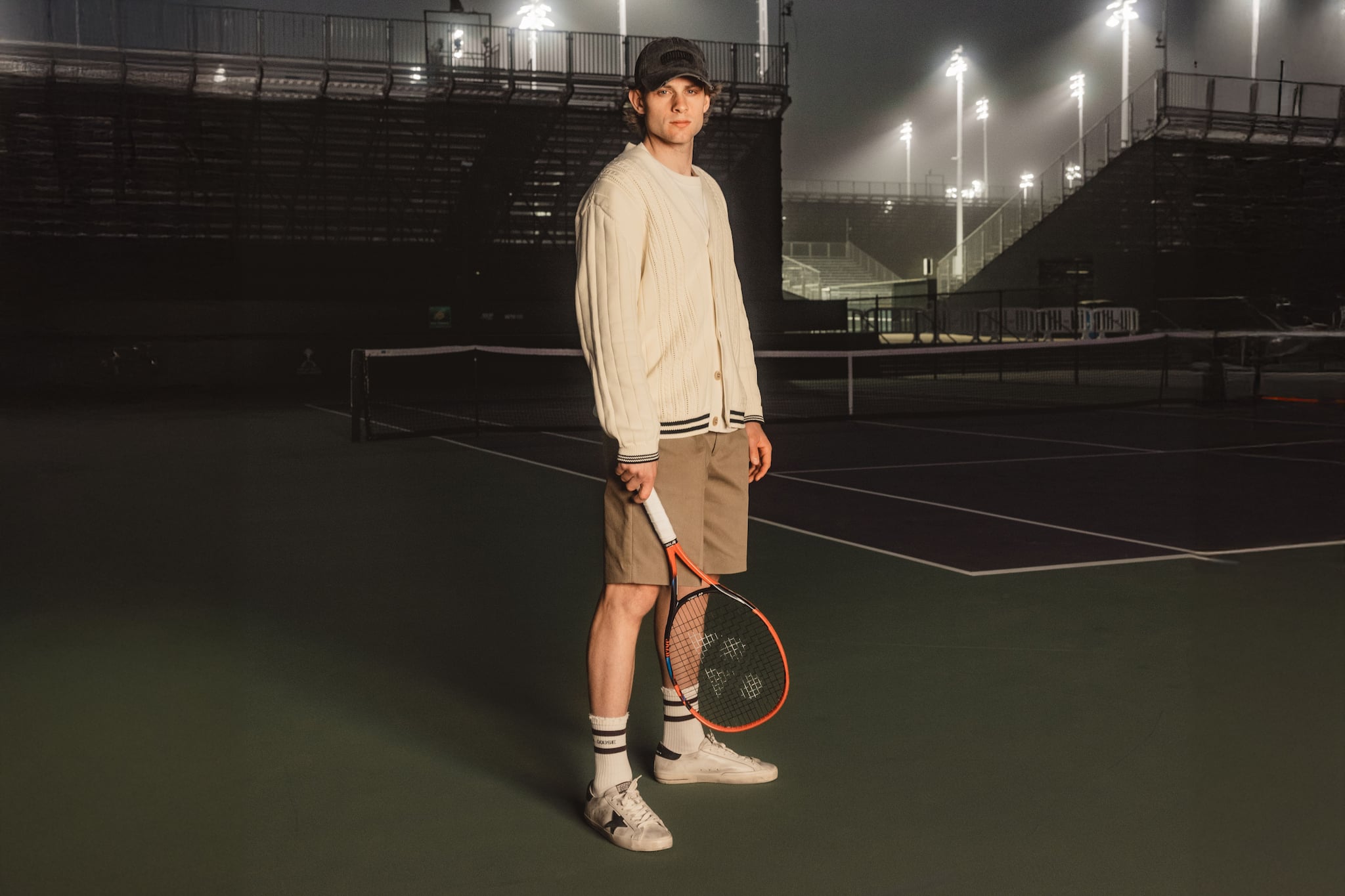 zizou-bergs-tennis-player-in-cardigan-on-court-at-night