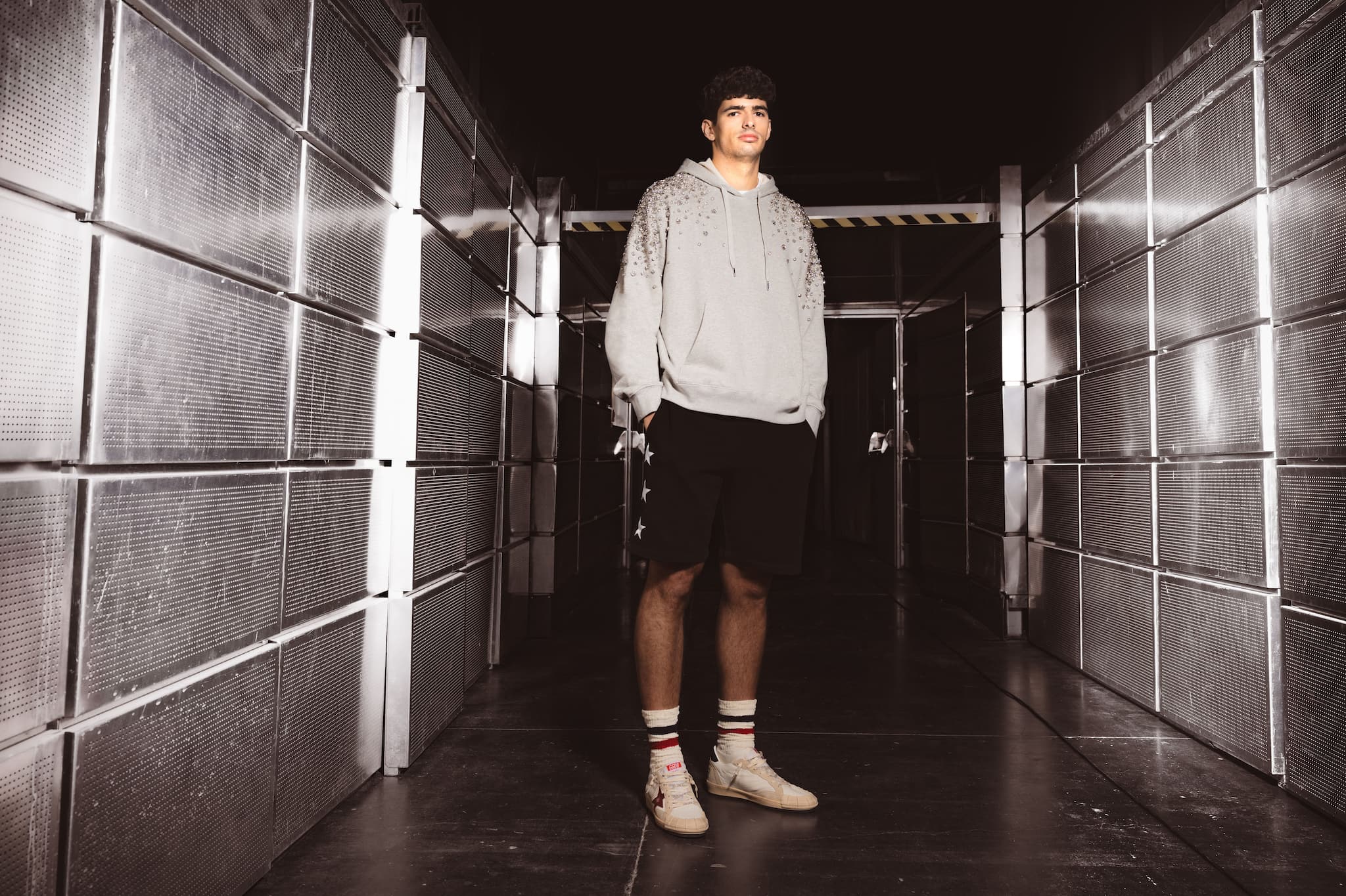 athlete-arturo-coello-in-stylish-hoodie-and-sneakers-in-metallic-corridor