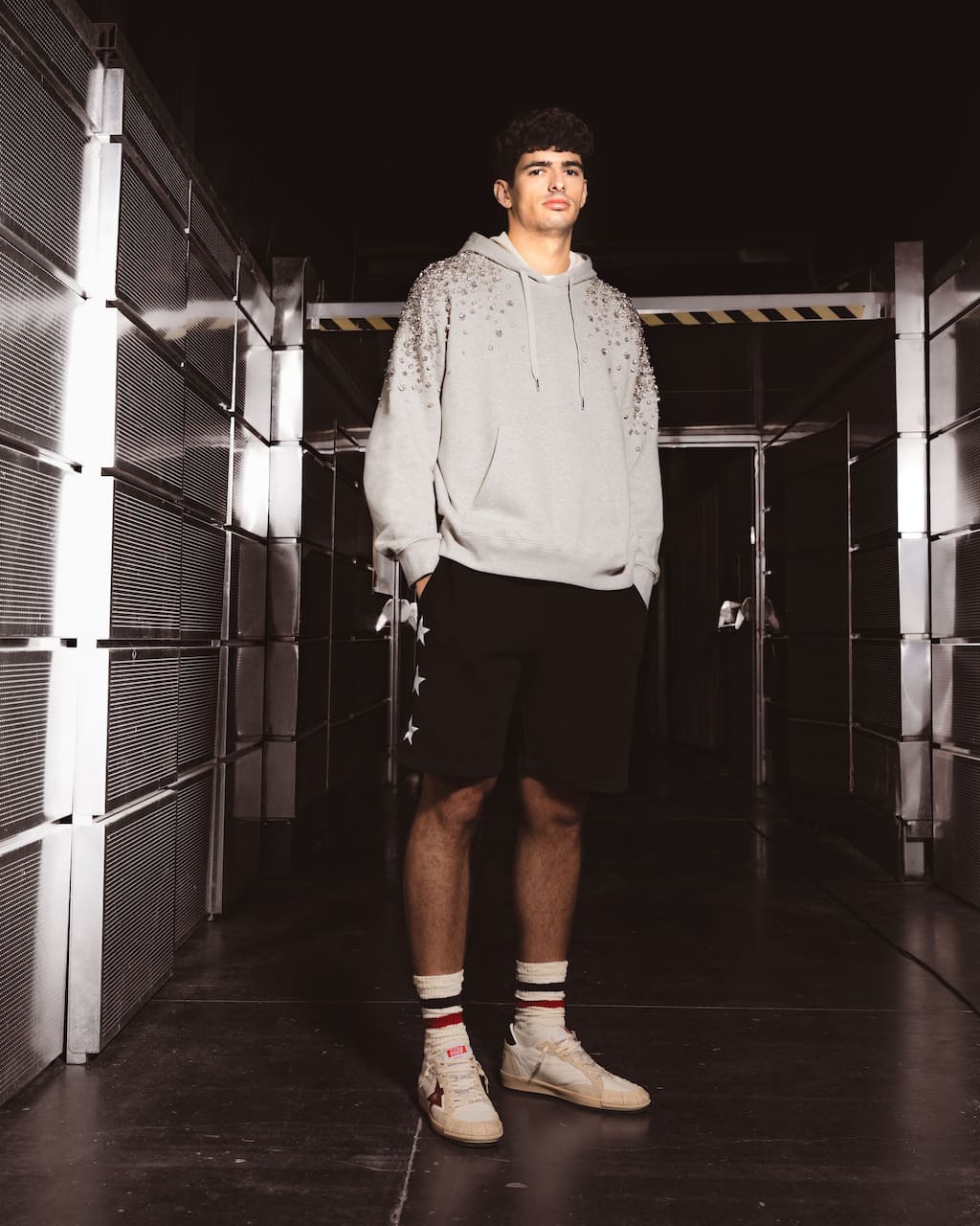 athlete-arturo-coello-in-stylish-hoodie-and-sneakers-in-metallic-corridor