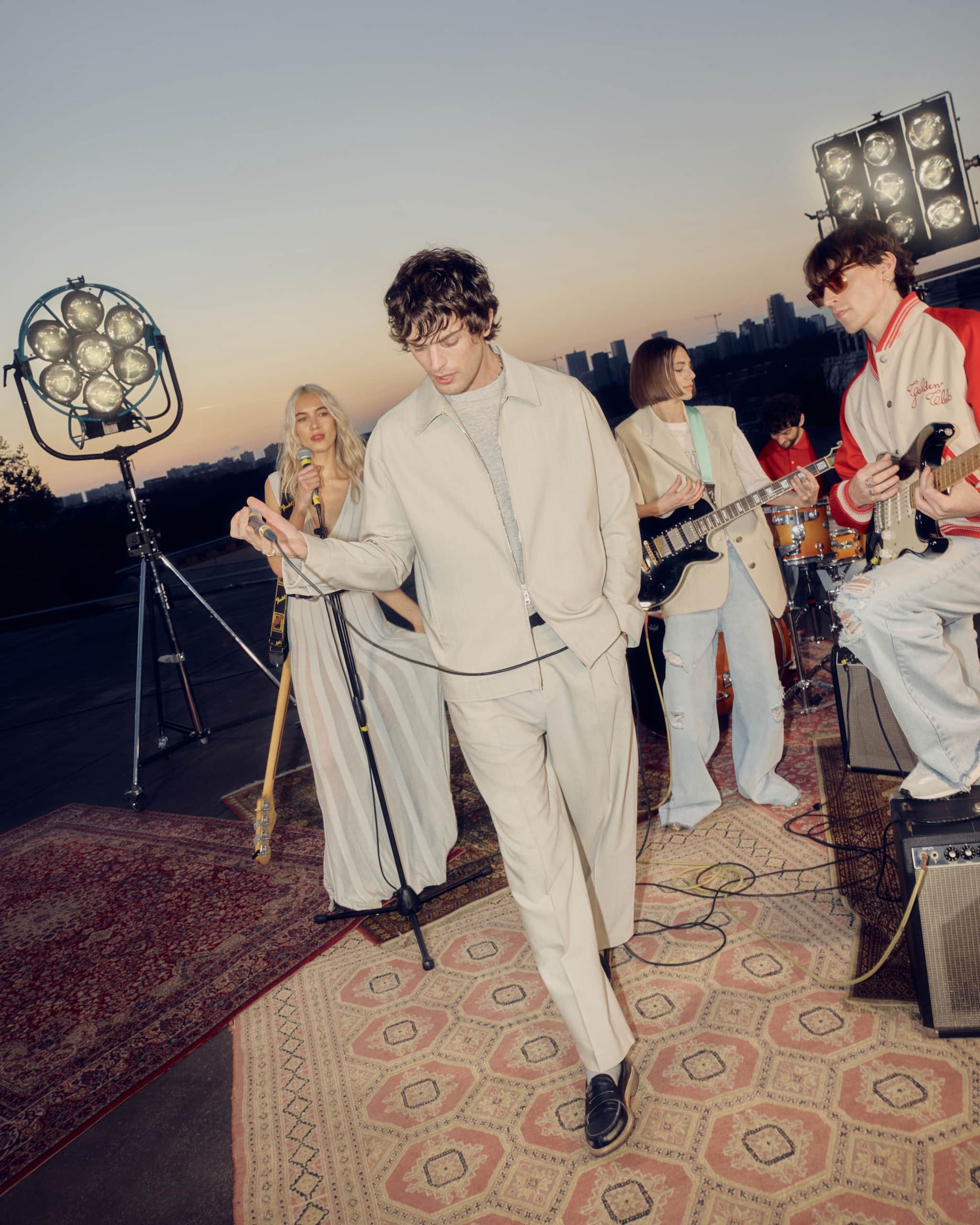 group-of-friends-singing-and-playing-instruments-on-a-rooftop
