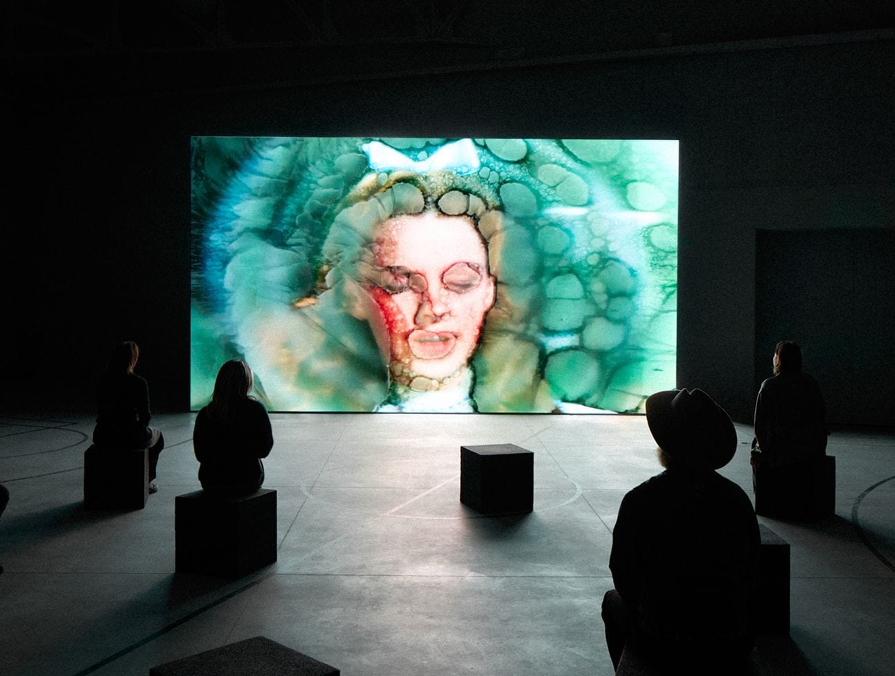 dreamy-portrait-of-woman-with-eyes-closed-and-aquamarine-cracked-texture-overlay