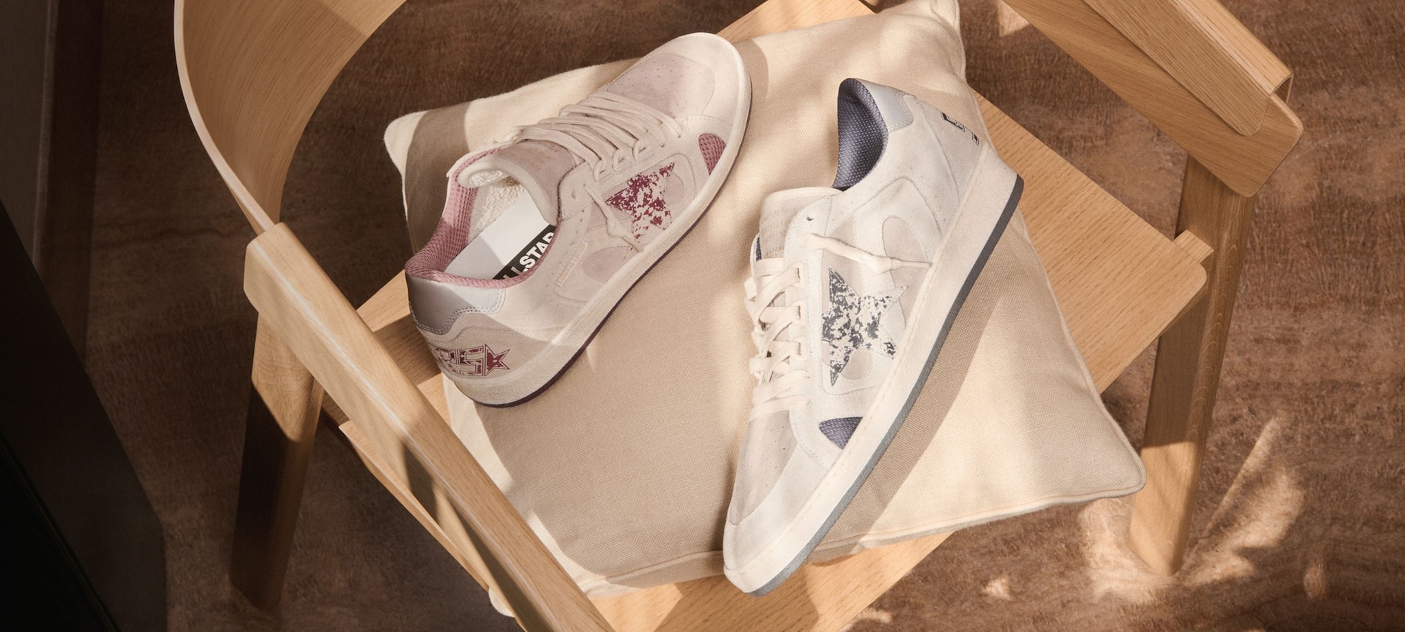 ballstar-sneakers-white-with-pink-star-and-ballstar-white-with-blue-star-on_a-wooden-chair