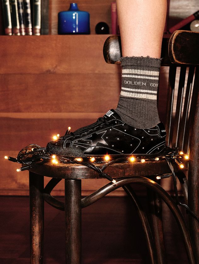 black-sneaker-on-a-chair-with-christmas-lights