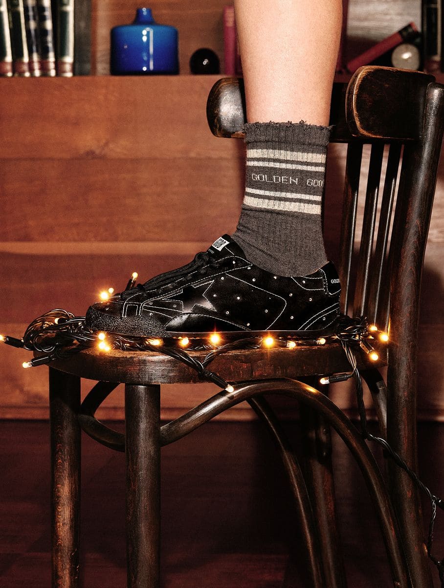 black-sneaker-on-a-chair-with-christmas-lights