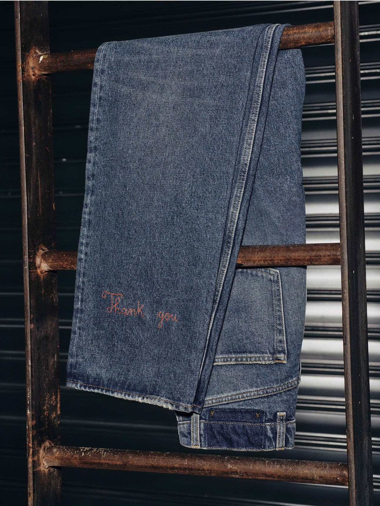 blue-denim-jeans-hanghinh-on-a-iron-staircase