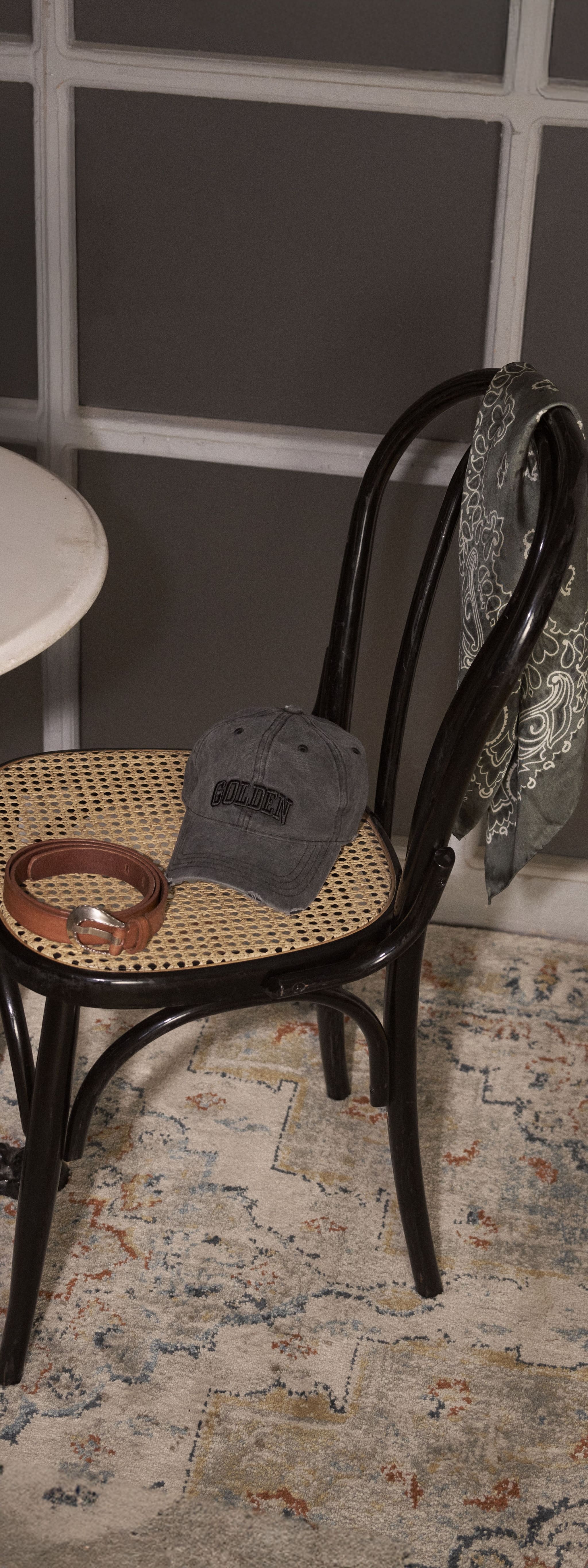 a-cap-and-a-belt-on-a-chair
