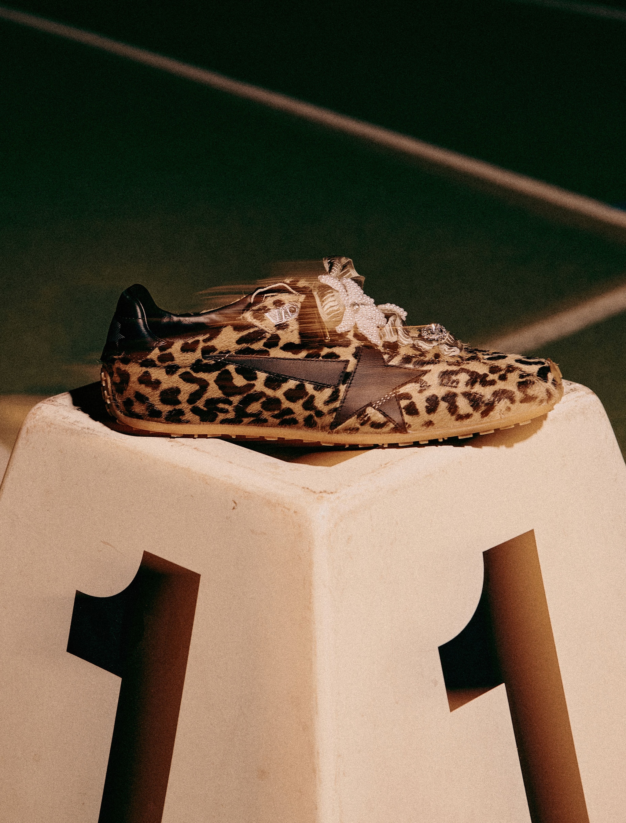 leopard-printed-marathon-speed-sneakers-on-a-pedestal