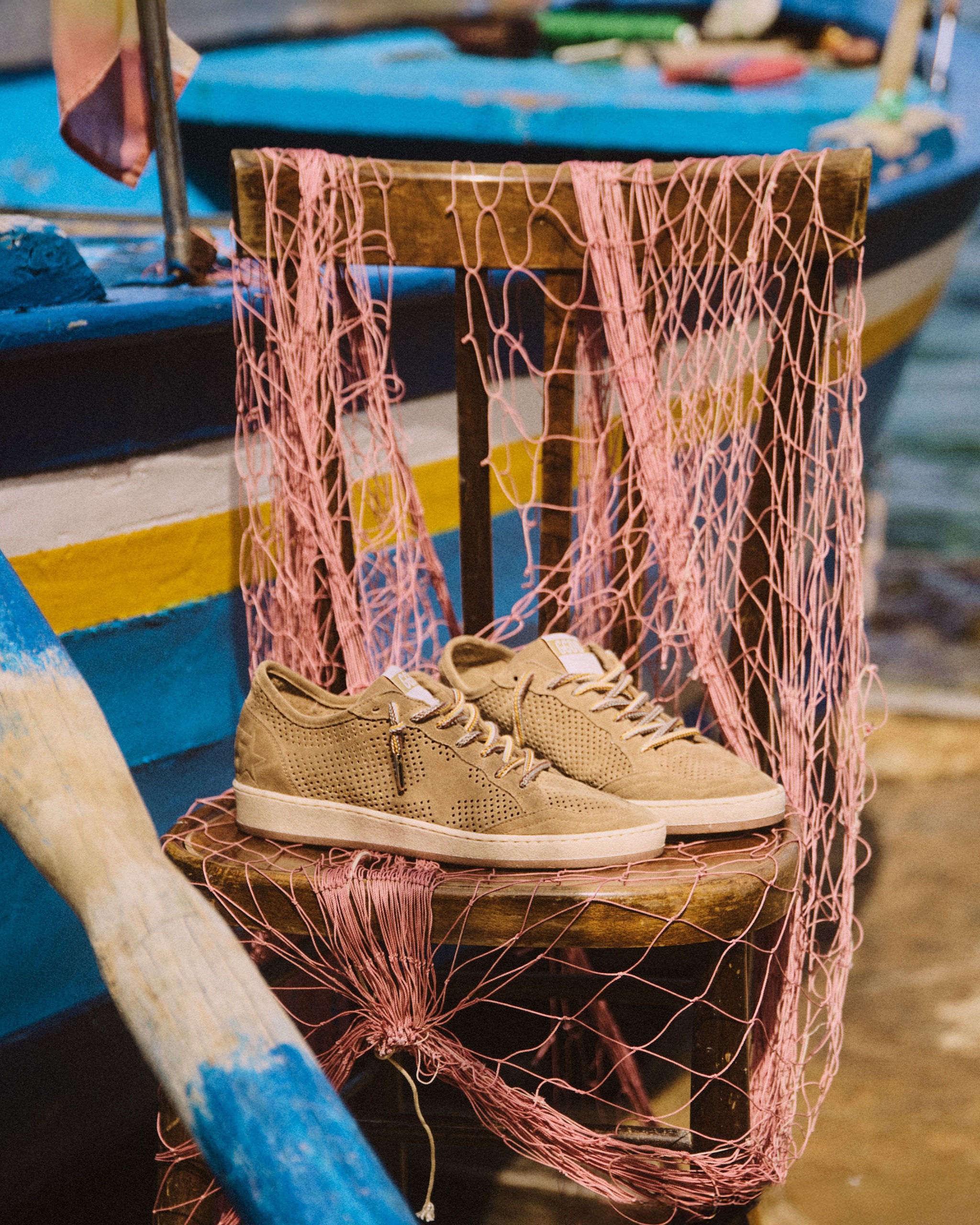 sneakers-leaning-against-a-pink-fishing-net