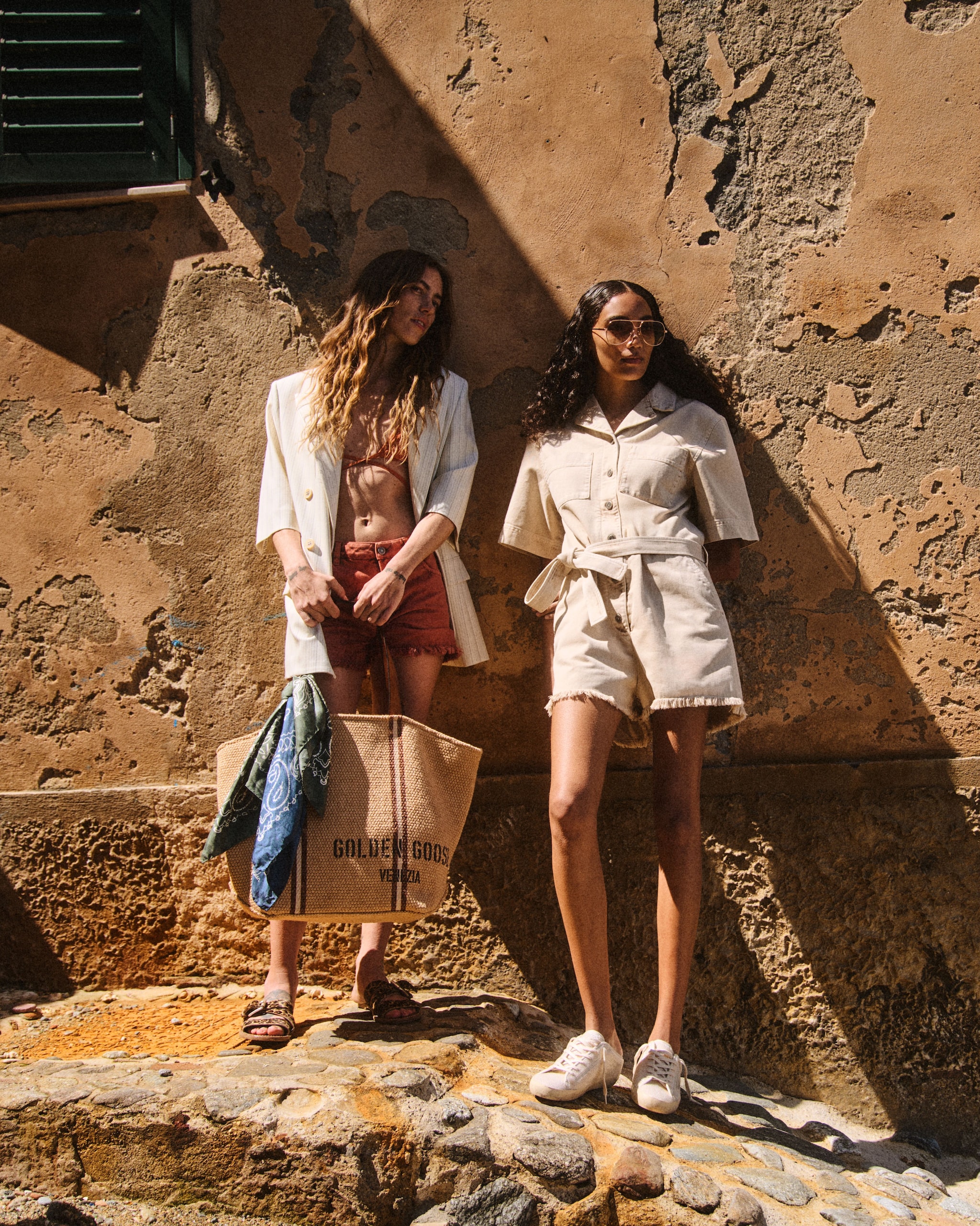 Two-girls-leaning-against-a-brick-wall