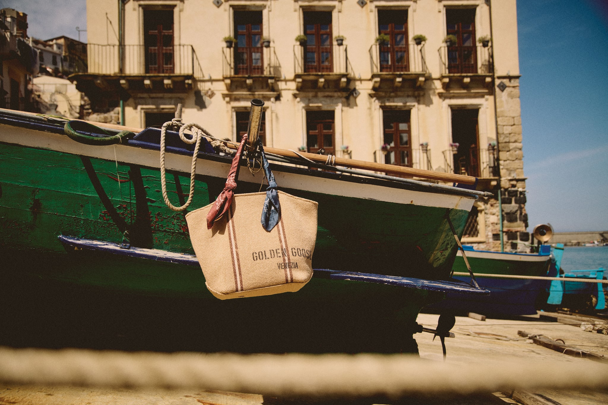 raffia-bag-hanging-from-a-boat-on-the-shore