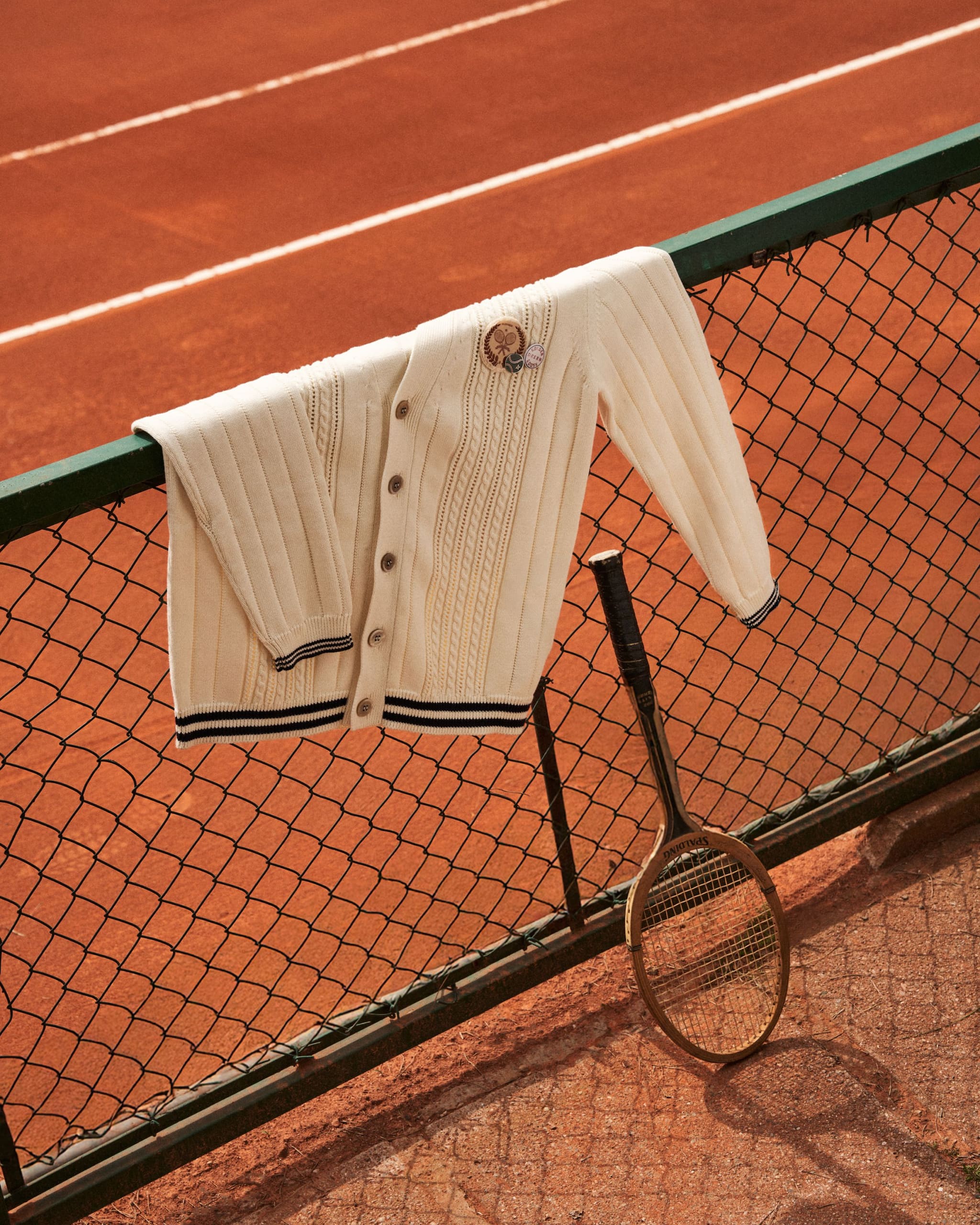 white-cardigan-on-a-net-in-a-tennis-field
