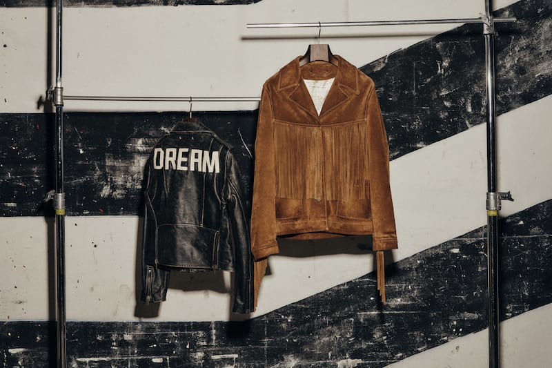 two-jackets-hanging-on-black-and-white-striped-wall