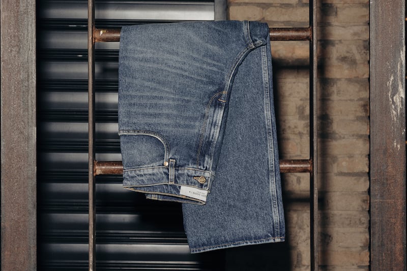 pair-of-jeans-resting-on-a-metal-ladder