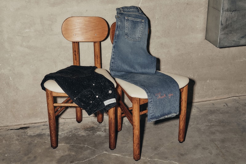 Women's-pair-of-black-glittered-pants-and-blue-jeans-on-two-chairs
