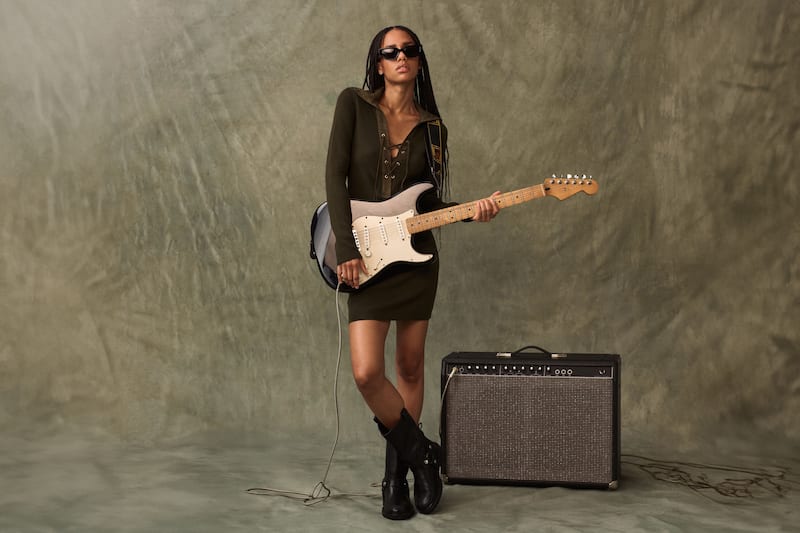 female-woman-wearing-a-dress-holding-a-guitar