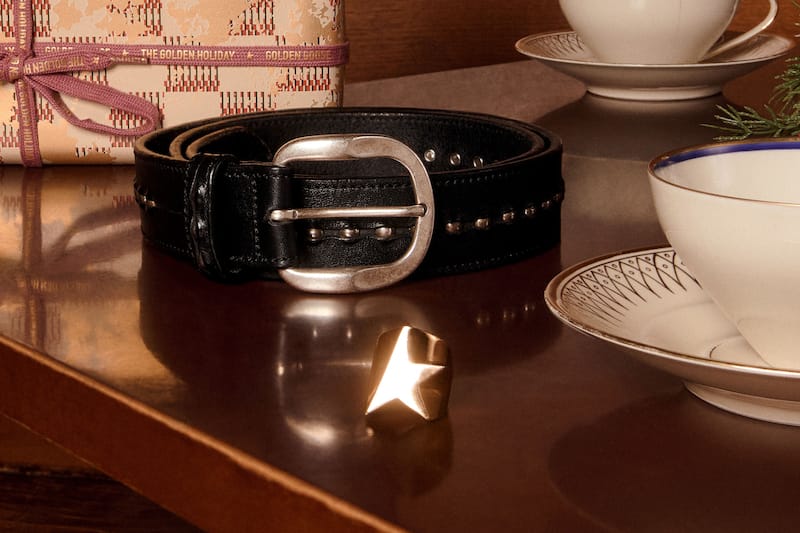 black-leather-belt-and-a-ring-on-a-table