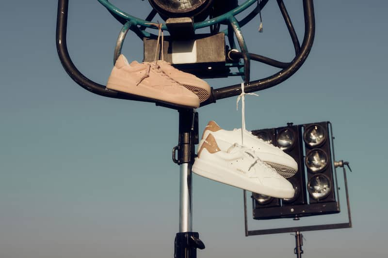 two-pair-of-pure-star-sneakers-hanging-on-film camera equipment