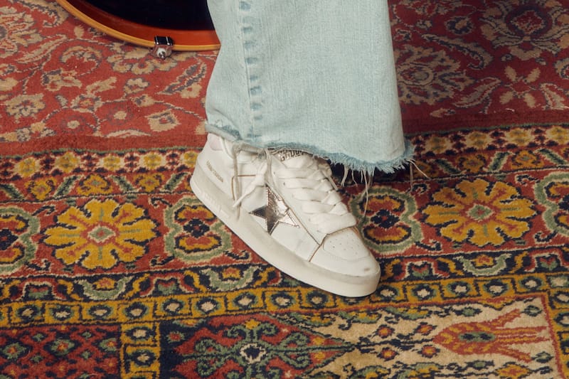 white-sneakers-with-metallic-star-on-vintage-rug