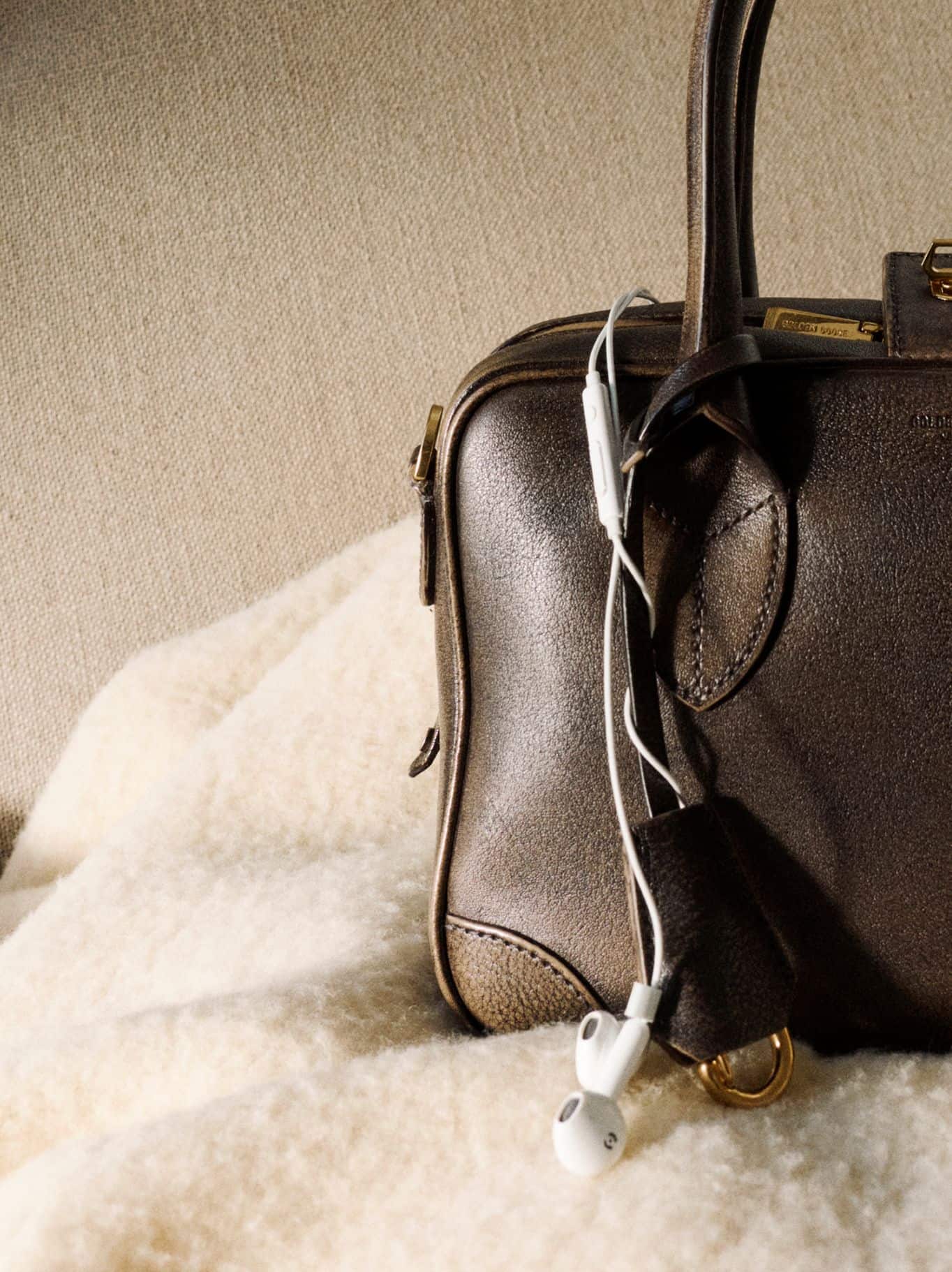 brown-leather-bag-with-ear-phones-inside