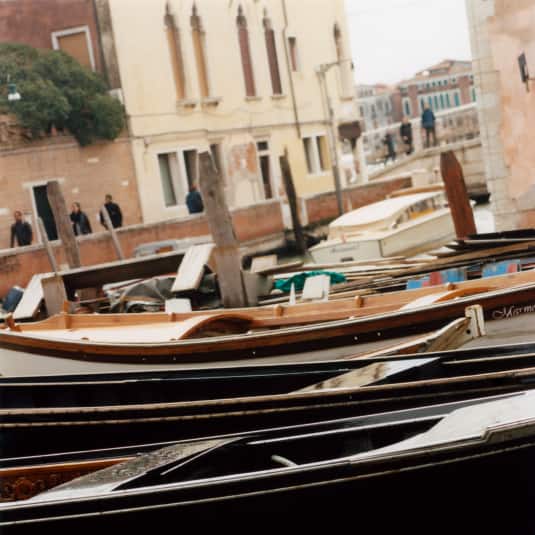 close-up-view-of-venetian-gondolas-on-the-side-of-a-canal