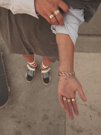 top-view-of-brooklinn-khoury-showing-gold-bracelets-and-rings