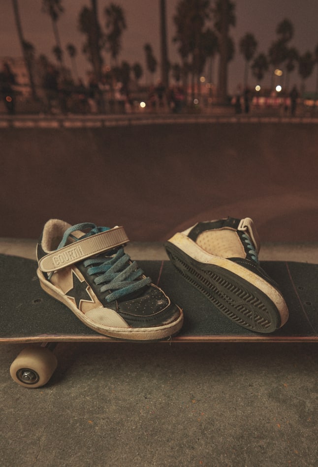 front-view-of-black-and-white-brooklinn-khoury-ball-star-pro-sneakers-on-skateboard