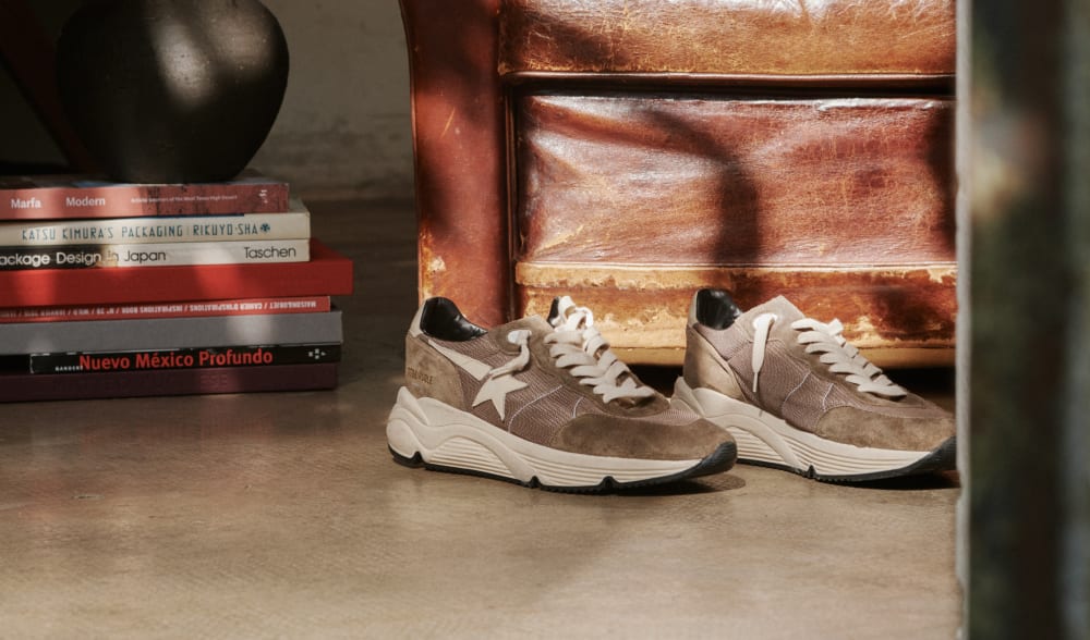 Running-Sole-sneakers-in-olive-green-leather-close-to-books