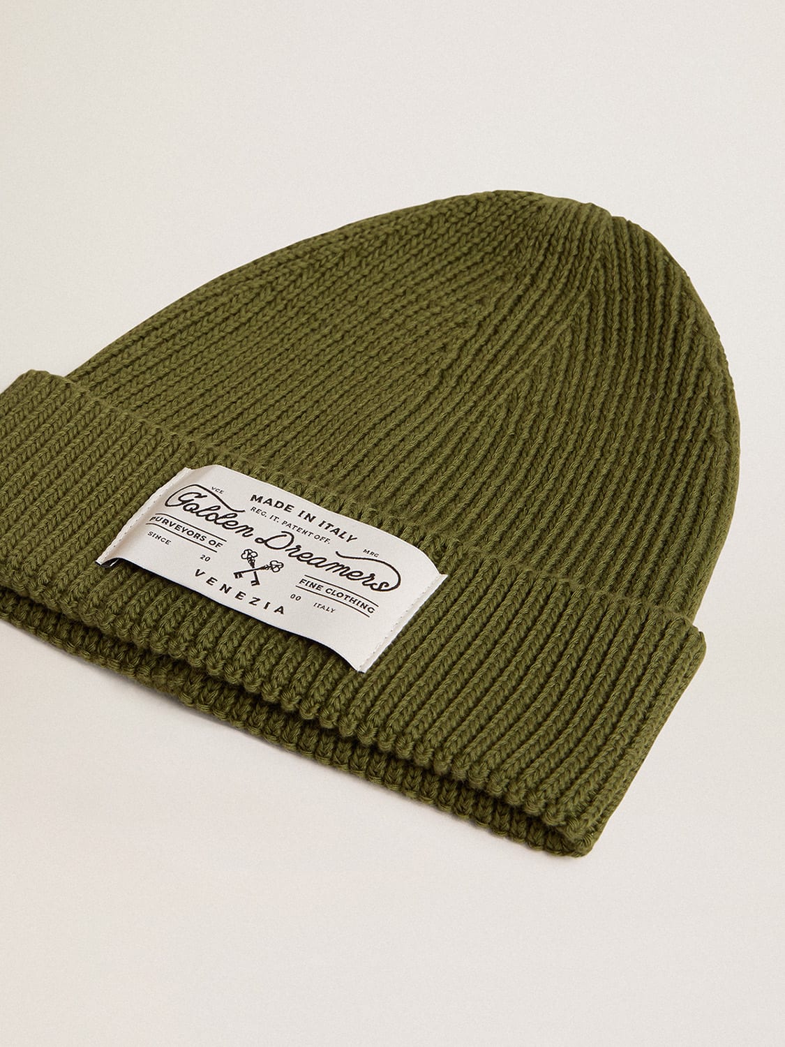 Military-green cotton beanie with appliqué label on the