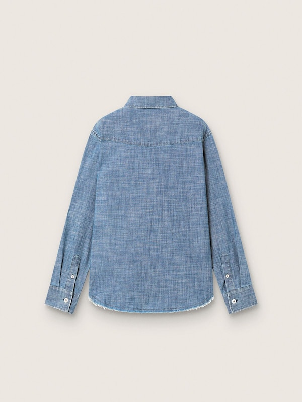 Journey unisex shirt in light blue cotton chambray with fringed hem and embroidered patch