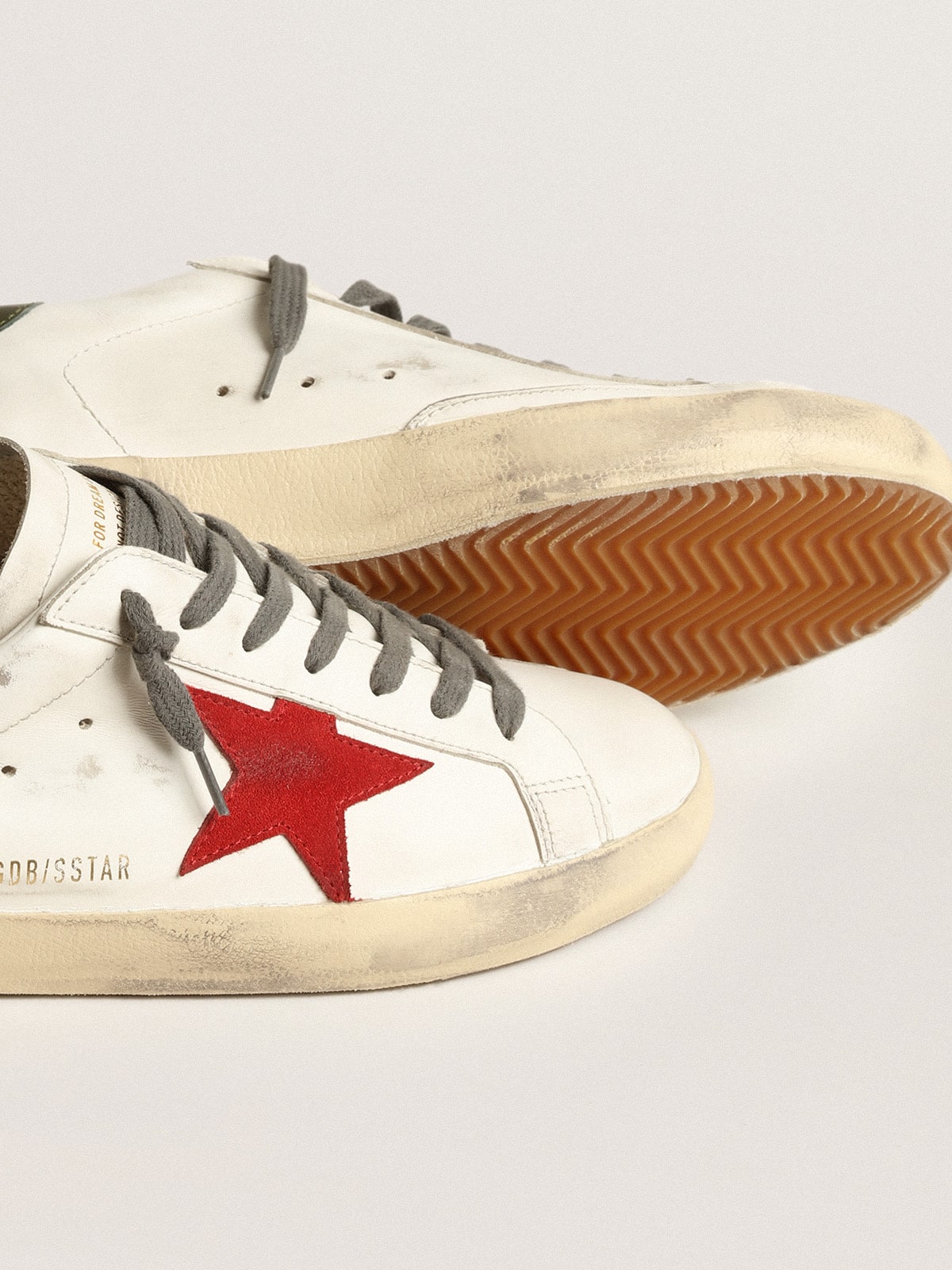 Super Star Uomo con stella in suede rosso e talloncino in pelle verde Golden Goose