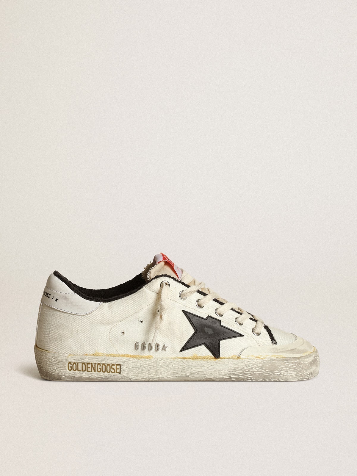 Men s Super Star LTD in beige canvas with black star Golden Goose