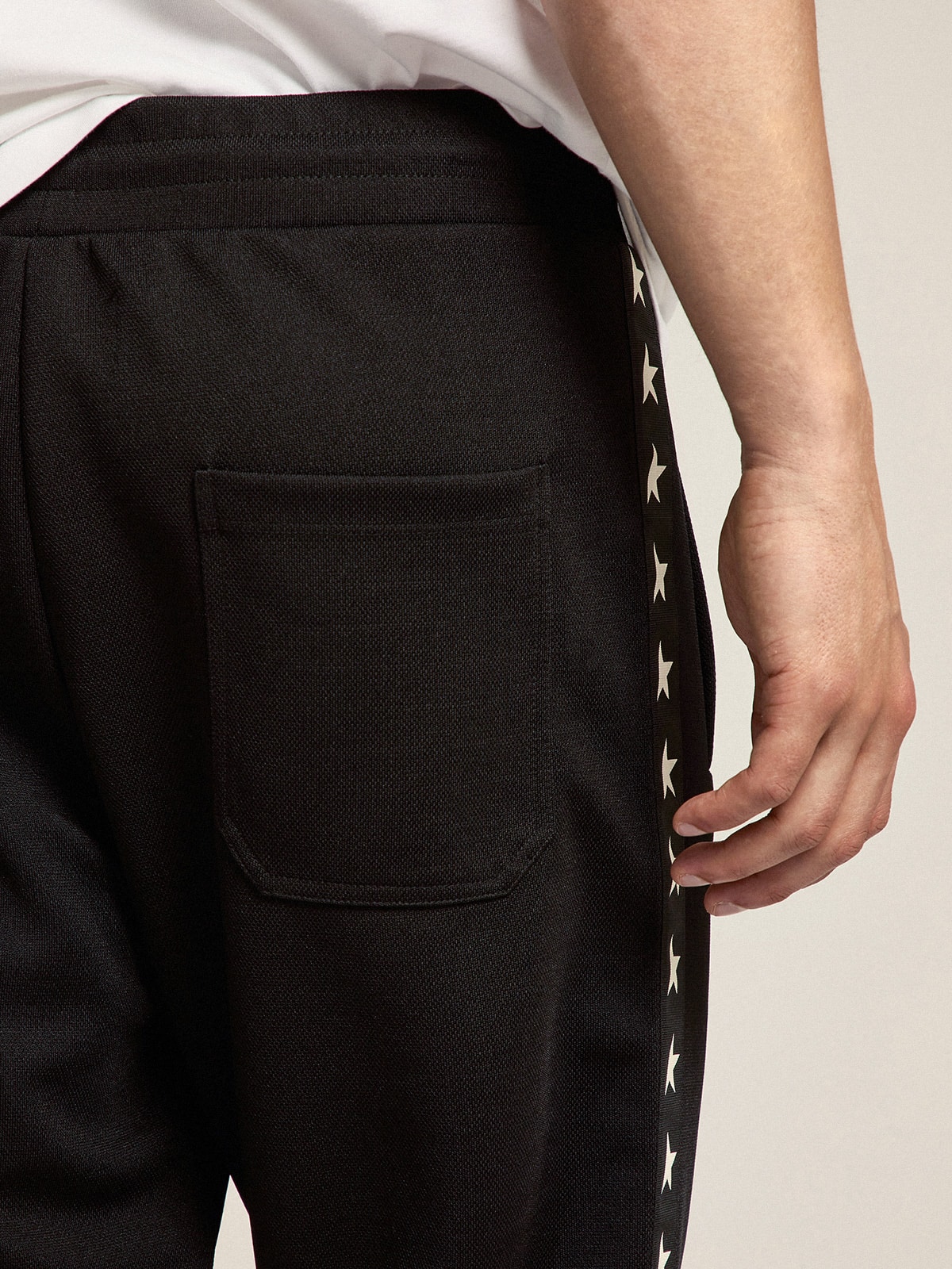 Golden Goose - Men's black joggers with white stars on the sides in 