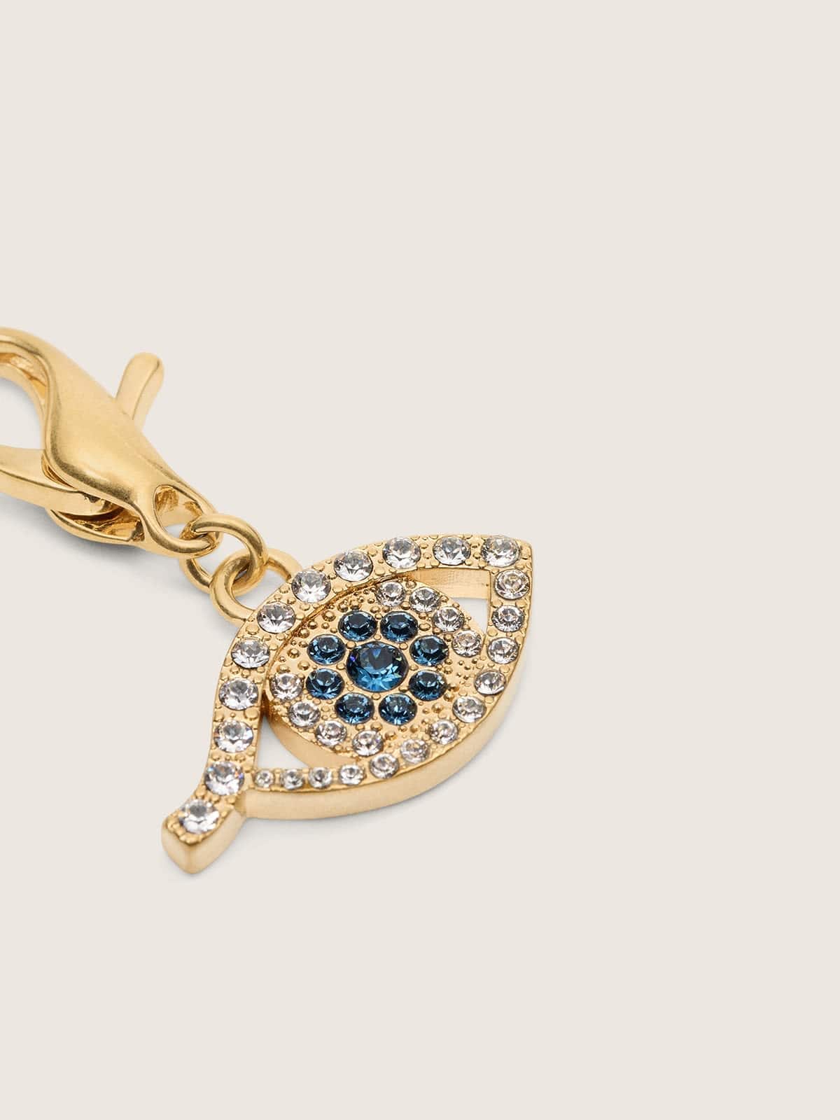 Pingente de latão em forma de olho dourado com cristais