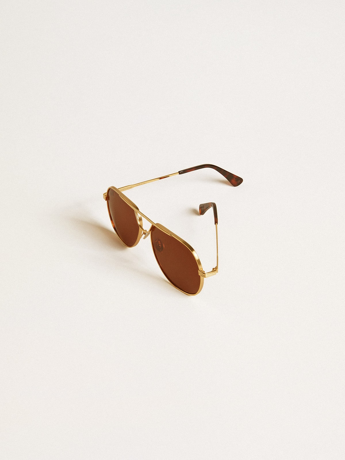 Aviator style sunglasses with gold frame and brown lenses