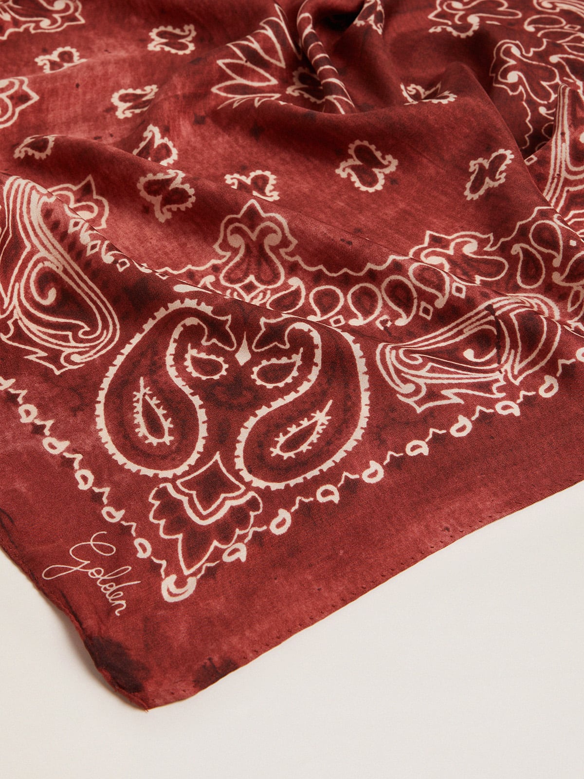 Burgundy scarf with paisley pattern