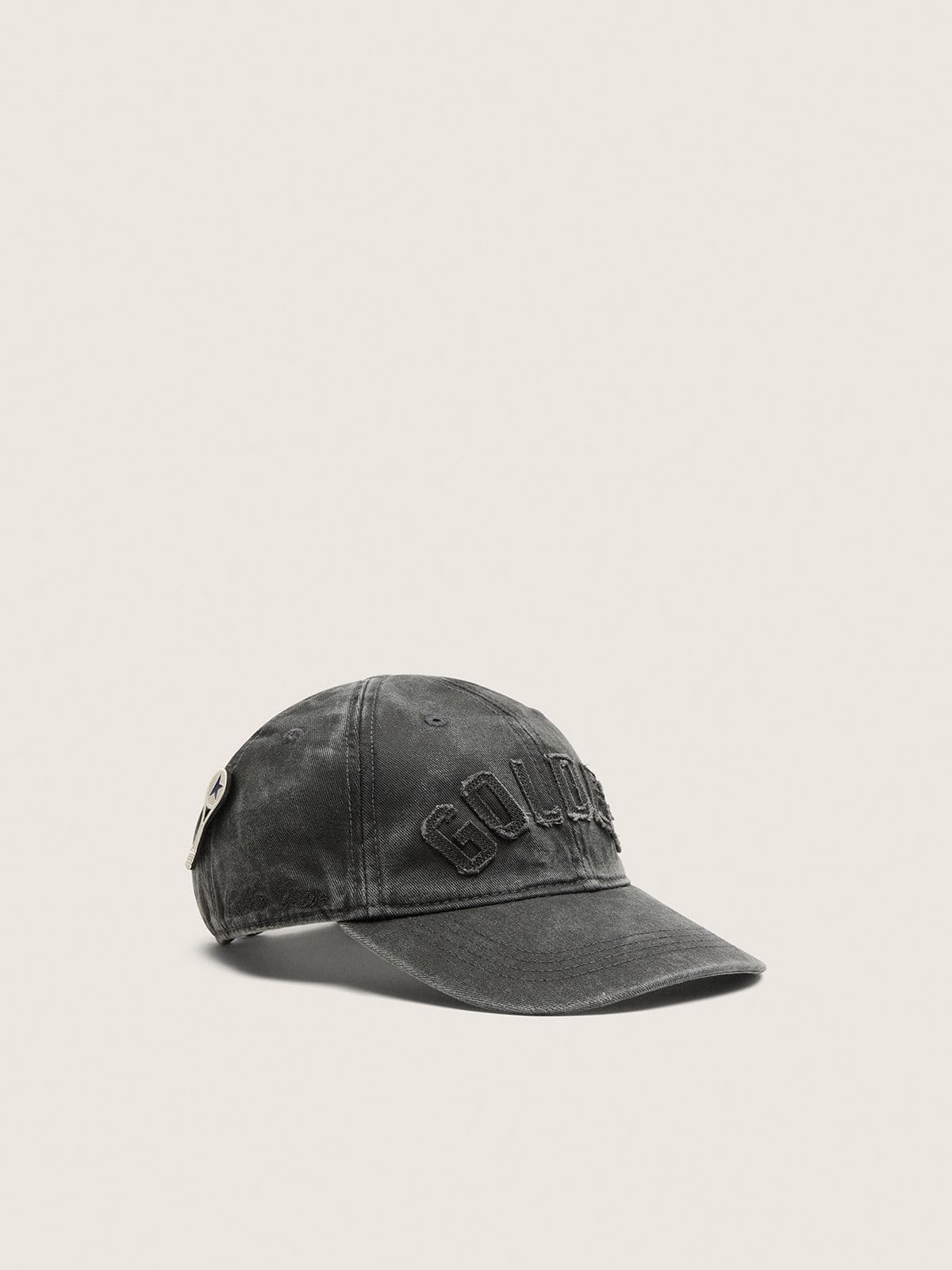 Anthracite baseball cap with a tone-on-tone &ldquo;Golden&rdquo; patch and a tennis racket pin