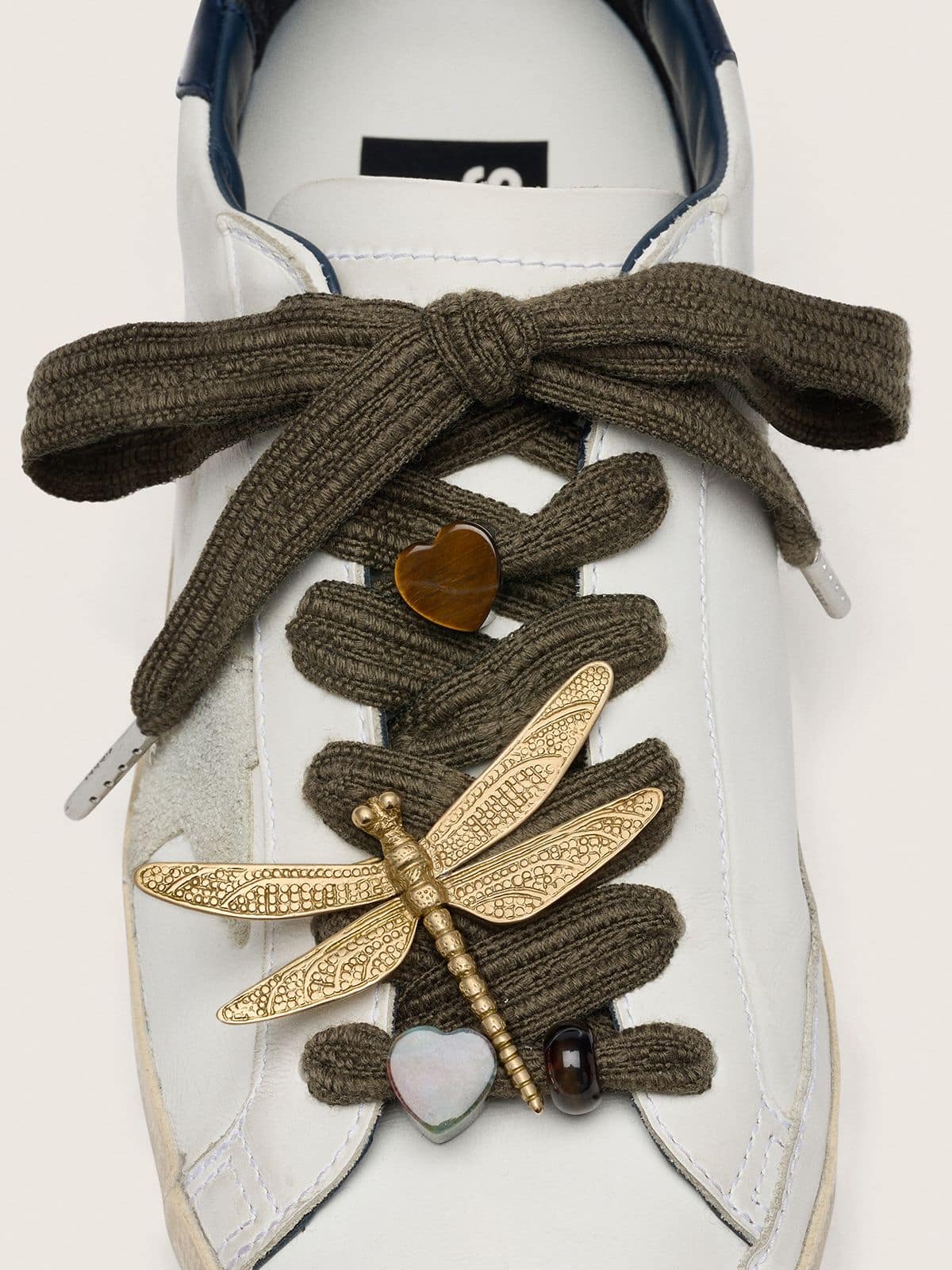 Skins dark green laces with dragonfly charm